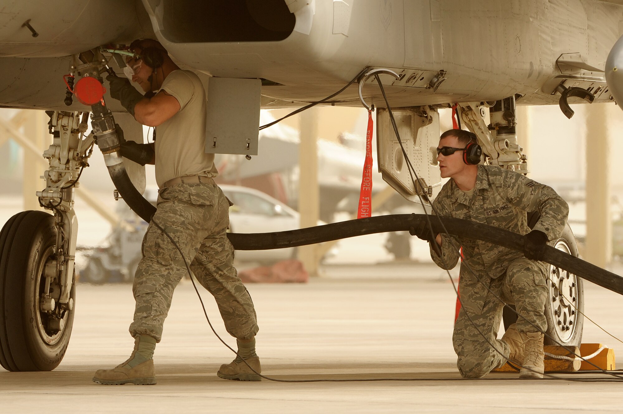 SOUTHWEST ASIA -Senior Airman James Cassata drags a refueling pump to an F-15 Eagle during hot pit refueling on the flightline March 2, 2012. Hot pit refueling is conducted to fuel aircraft while they are still running to reduce ground time and get aircraft back up in the air as soon as possible. Cassata is assigned to the 380th Expeditionary Logistics Readiness Squadron and is assigned to Shaw Air Force Base, S.C. (U.S. Air Force photo/Tech. Sgt. Arian Nead)


