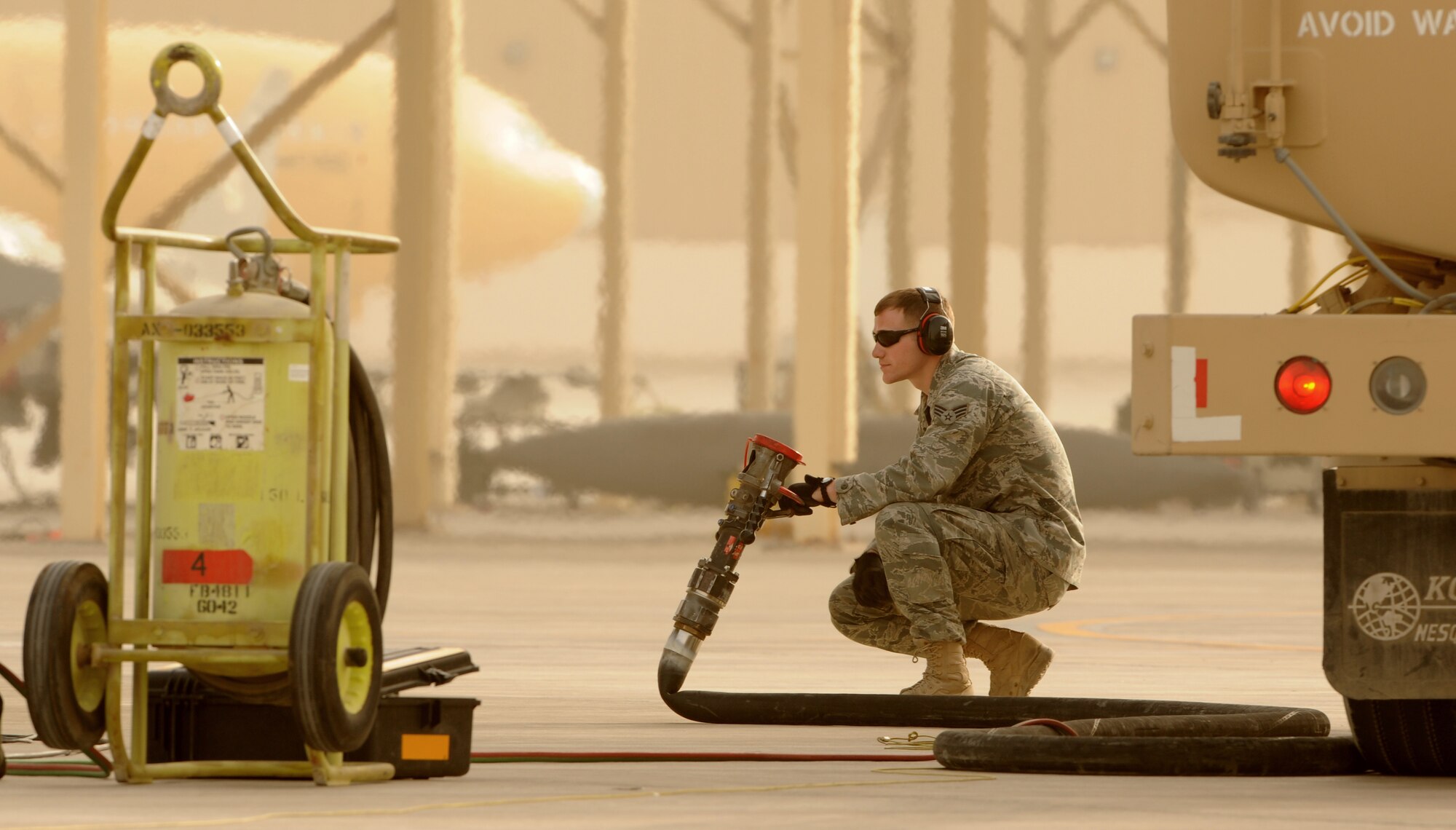 SOUTHWEST ASIA -Senior Airman James Cassata drags a refueling pump to an F-15 Eagle during hot pit refueling on the flightline March 2, 2012. Hot pit refueling is conducted to fuel aircraft while they are still running to reduce ground time and get aircraft back up in the air as soon as possible. Cassata is assigned to the 380th Expeditionary Logistics Readiness Squadron and is assigned to Shaw Air Force Base, S.C. (U.S. Air Force photo/Tech. Sgt. Arian Nead)


