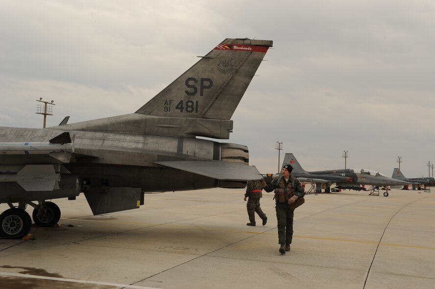 KONYA, Turkey -- Maj. Kevin Fisher, 480th Fighter Squadron pilot, inspects an F-16 Fighting Falcon before takeoff during Exercise Anatolian Falcon 2012. During the bilateral training exercise the squadron will fly missions including air interdiction, attack, air superiority, defense suppression, airlift, air refueling and reconnaissance. (U.S. Air Force photo/Staff Sgt. Benjamin Wilson)