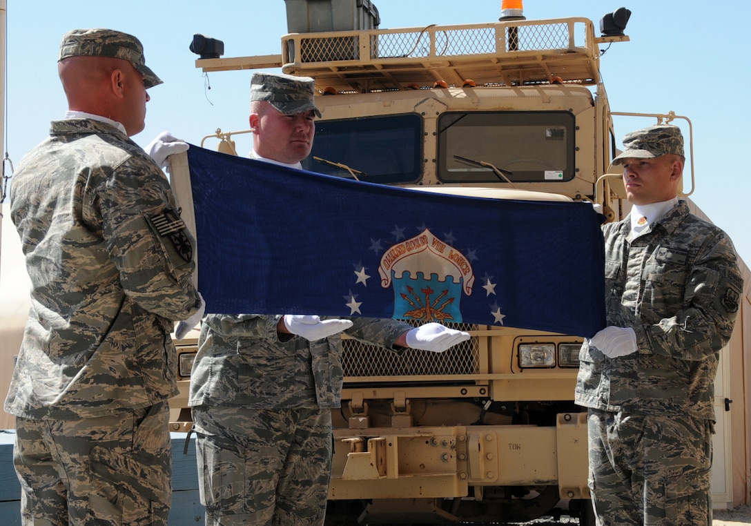 U.S. Air Force 387th Expeditionary Logistics Readiness Squadron combat truckers fold the Air Force flag during their inactivation ceremony at an undisclosed location in Southwest Asia, March 6, 2012. The 387th ELRS participated in the largest retrograde of cargo and personnel since World War II; U.S. Central Command approved the 387th ELRS as "mission complete" and authorized them to inactivate on Dec. 20, 2011. (U.S. Air Force photo by Staff Sgt. James Lieth/Released)