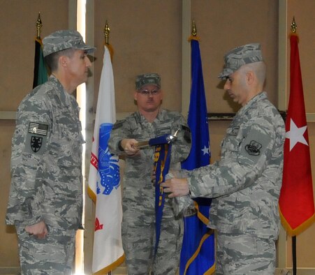U.S. Air Force Lt. Col. John O'Connor (right), commander of the 387th Expeditionary Logistics Readiness Squadron, furls his squadron's colors during an inactivation ceremony at an undisclosed location in Southwest Asia on March 6, 2012. The 387th ELRS participated in the largest retrograde of cargo and personnel since World War II; U.S. Central Command approved the 387th ELRS as "mission complete" and authorized them to inactivate on Dec. 20, 2011. (U.S. Air Force photo/Staff Sgt. James Lieth)