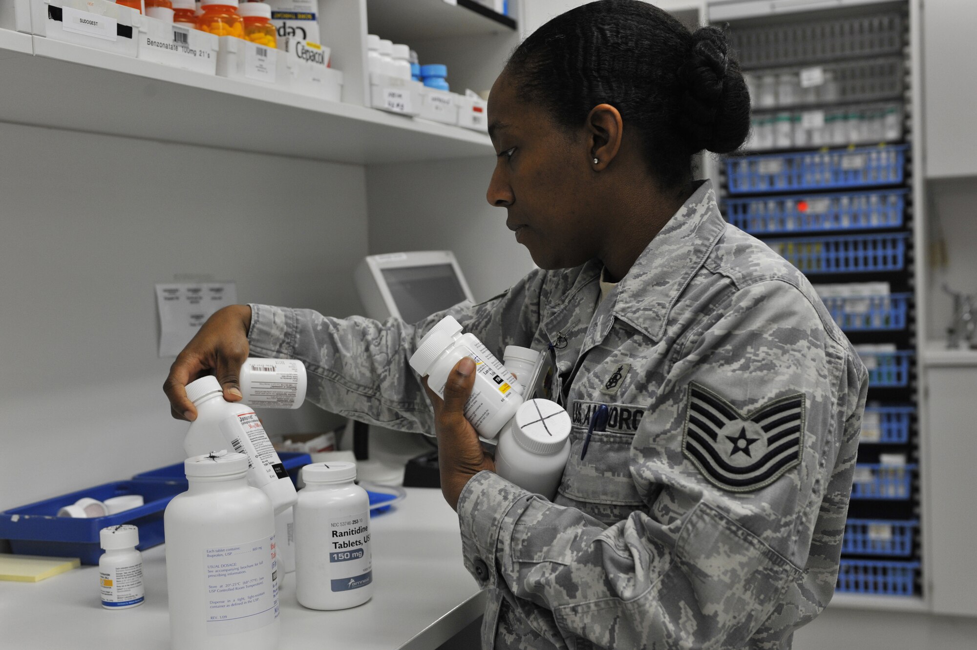 U.S. Air Force Tech. Sgt. Sherrilyn Smith, 86th Medical Group pharmacy technician, organizes bottles of prescriptions for military members and retirees, Ramstein Air Base, Germany, March 6, 2012. The 86th Medical Group Pharmacy fills 400 prescriptions any normal duty day to include a variety of medication and requested special orders. (U.S. Air Force photo/Airman 1st Class Caitlin O'Neil-McKeown)  