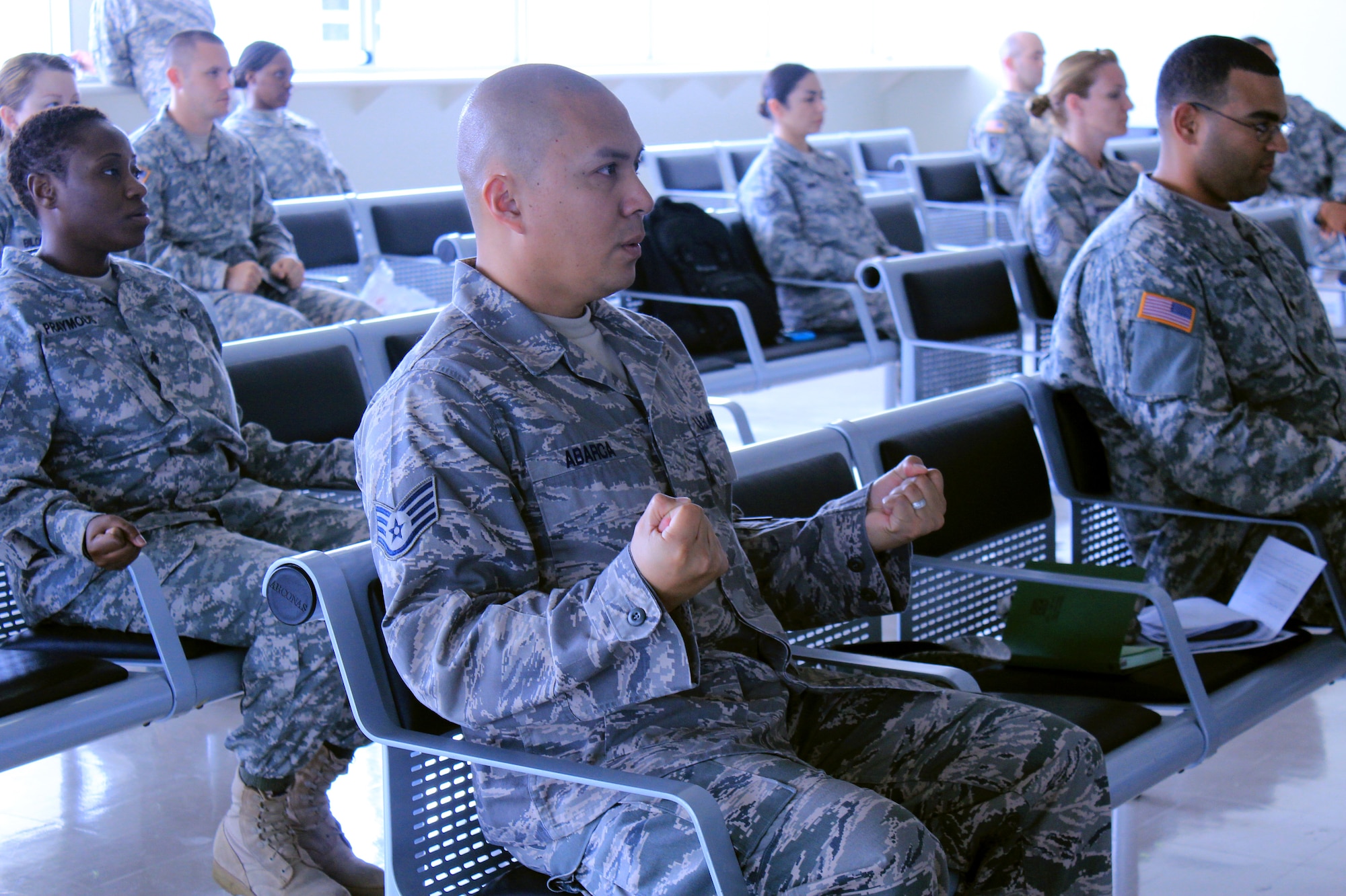 U.S. Air Force and Army members practice calming breathing techniques during a week-long joint assistant resiliency trainer course Feb. 21-27, 2012 at Kadena Air Base, Japan. The resiliency course, developed by the Army along with the University of Pennsylvania, provides members with the tools to combat stressful situations before they become bigger problems. (Courtesy photo by Ashleigh Craig/released)