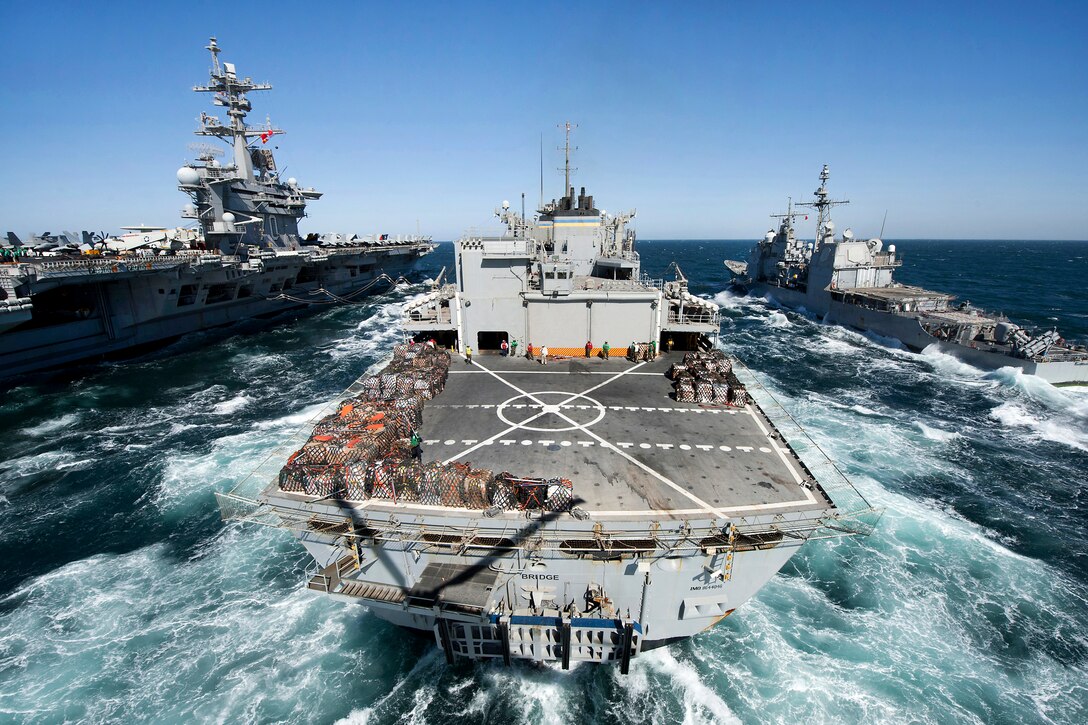 The Military Sealift Command fast combat support ship USNS Bridge, center, prepares to conduct a replenishment at sea with the aircraft carrier USS Carl Vinson, left, and the guided missile cruiser USS Bunker Hill, right, in the Arabian Gulf, March 6, 2012.