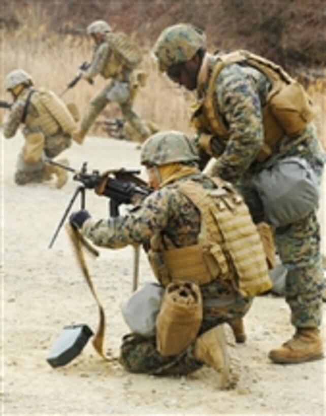 U.S. Marine Corps Sgt. Wendell Claxon, assigned to 2nd Platoon, Fleet Antiterrorism Security Team Company Pacific, instructs Lance Cpl. Rudy Pineda on the next course of fire while participating in a live-fire exercise at Camp Rodriguez, South Korea, on March 4, 2012.  