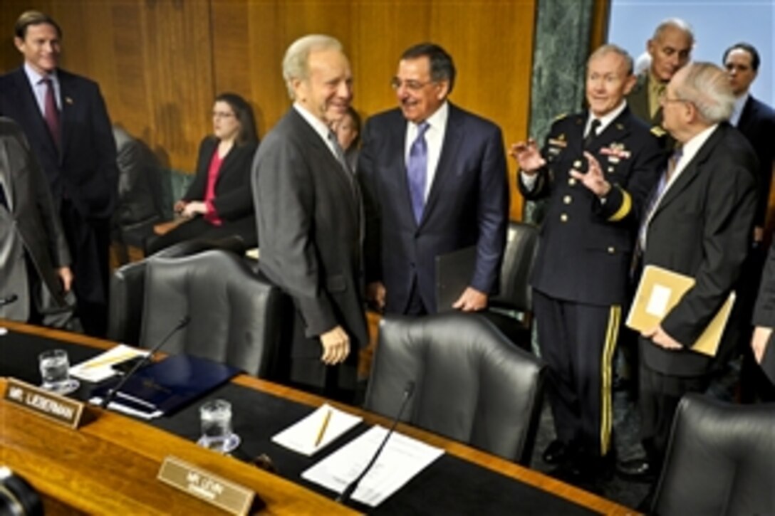 Defense Secretary Leon E. Panetta, center, and Army Gen. Martin E. Dempsey, chairman of the Joint Chiefs of Staff, talk with U.S. Sens. Joe Lieberman of Connecticut, left, and Carl Levin of Michigan, chairman of the Senate Armed Services Committee, in Washington, D.C., March 7, 2012. Panetta and Dempsey later testified on the situation in Syria before committee members.