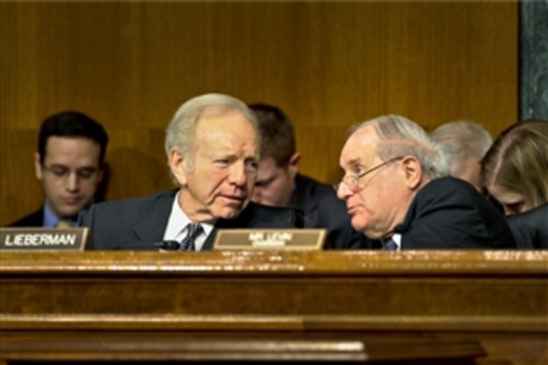 U.S. Sen. Joe Lieberman of Connecticut, left, and Carl Levin of Michigan confer as Defense Secretary Leon E. Panetta and Army Gen. Martin E. Dempsey, chairman, Joint Chiefs of Staff, testify on the situation in Syria before the Senate Armed Services Committee in Washington, D.C., March 7, 2012. Levin in the committee's chairman.