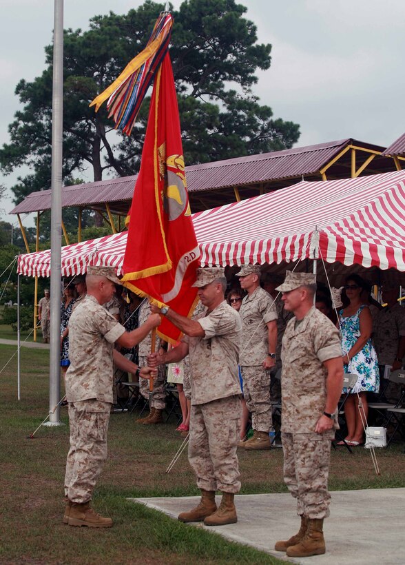 Col. Paul J. Kennedy, the former commanding officer of 2nd Marine Regiment, 2nd Marine Division, faces away from the audience while receiving the guidon from Sgt. Maj. George W. Young Jr., the regimental sergeant major, during a change of command ceremony aboard Marine Corps Base Camp Lejeune, N.C., July 14, 2011. Kennedy relinquished his command to Col. William M. Jurney after leading the regiment for the past three years.