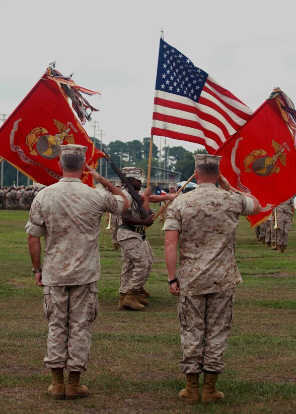 Col. Paul J. Kennedy and Col. William M. Jurney salute the colors during a change of command ceremony aboard Marine Corps Base Camp Lejeune, N.C., July 14, 2011. Kennedy relinquished his command to Jurney after leading the regiment for the past three years.