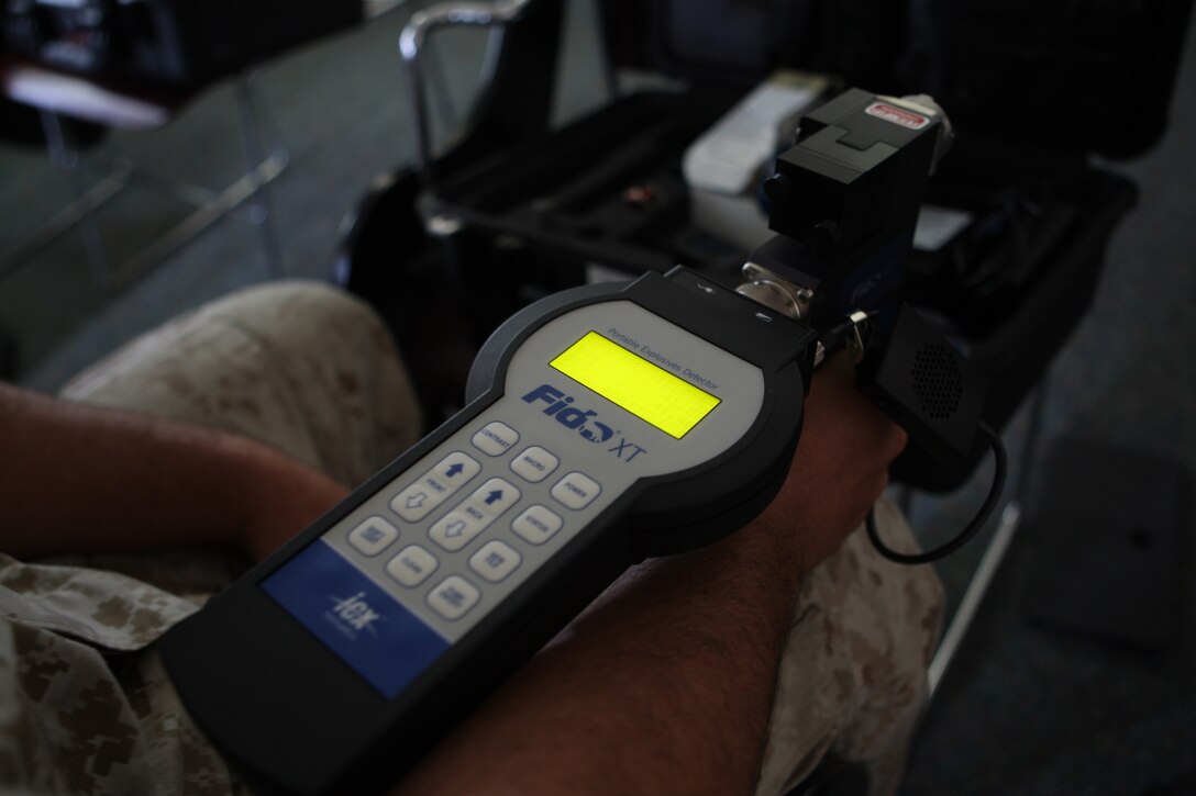 Lance Cpl. Andrew Gabbard, a patrolman with the Provost Marshal’s Office, equips the Fido Portable Explosives Detector during a training seminar at PMO’s headquarters building aboard Marine Corps Base Camp Lejeune, June 13. The Fido detection system is able to analyze air molecules in an effort to “sniff out” bomb materials’ scents, either in cars or on the clothes of a suspect.