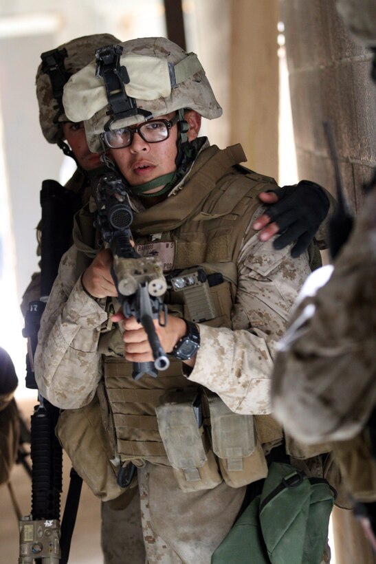 Lance Cpl. William Barrios with 3rd platoon, Company F, Anti-Terrorism Battalion, attached to 2nd Marine Division, takes point before clearing a room during the Basic Urban Skills Training course at the Military Operations on Urban Terrain facility aboard Marine Corps Camp Lejeune, July 7, 2011. The BUST is a week-long course, covering a multitude of skills such as basic room clearing techniques, fireteam movement on urban terrain and techniques for patrolling through an urban setting.