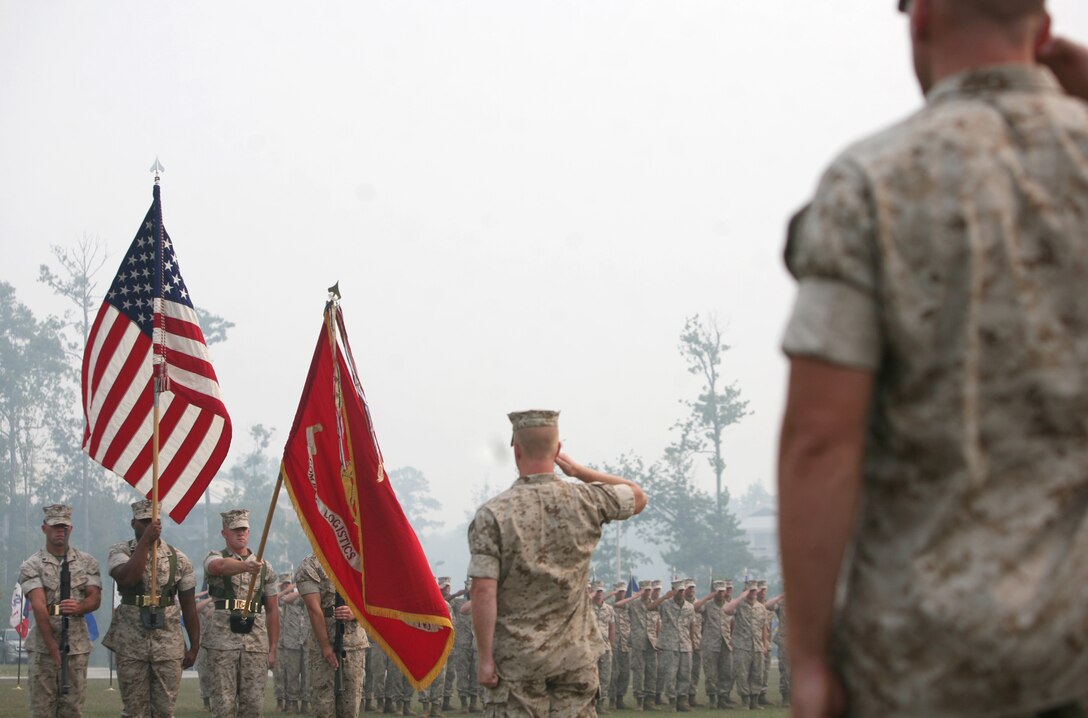 Staff members render honors as the National Anthem plays during the Combat Logistics Battalion 2 change of command ceremony at Soifert Field aboard Camp Lejeune, N.C., July 7. Lt. Col. Brian N. Wolford relinquished command to Lt. Col. Denise M. Mull. (U.S. Marine Corps photo by Sgt. Justin J. Shemanski)