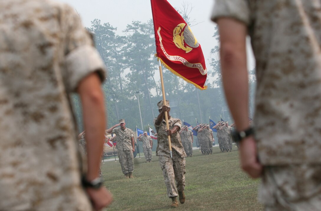 Sgt. Maj. Stephanie Murphy (center), the battalion sergeant major for Combat Logistics Battalion 2, 2nd Marine Logistics Group, delivers the unit colors to Lt. Cols. Brian N. Wolford and Denise M. Mull during the unit’s change of command ceremony at Soifert Field aboard Camp Lejeune, N.C., July 7. After relinquishing command to Mull, Wolford will report to the Industrial College of the Armed Forces in Fort McNair, Washington. (U.S. Marine Corps photo by Sgt. Justin J. Shemanski)