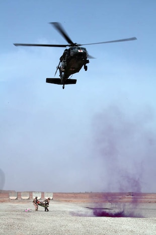 U.S. Navy Corpsman, with the Shock and Trauma Platoon (STP), Regimental Combat Team 8 (RCT-8), conduct a skid and hoist drill on April 8, 2011 at U.S. Marine Corps base Camp Delaram 2, Afghanistan. U.S. Navy Corpsman carry a skid litter to the landing zone so that the crew on a UH-60 Blackhawk can hoist up the casualty. This type of evacuation is performed when a landing zone is inadequate due to extreme terrain. (U.S. Marine Corps photo by Lance Cpl. Justin Davis)
