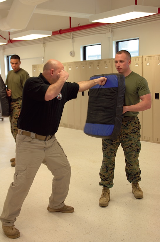 David Ward, left, instructor, Marine Corps Police Department, demonstrates the proper way to deliver a front jab, recently.