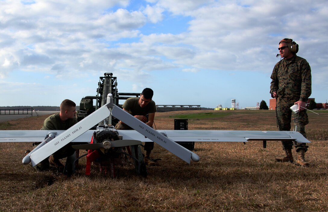 Lance Cpl. Brandon Dunlow, left, Lance Cpl. Eric Garcia, middle, and Sgt. Mark M. Buhler, all avionics technicians with Marine Unmanned Aerial Vehicle Squadron 2, prepare an RQ-7B Shadow for takeoff on Marine Corps Air Station Cherry Point’s flight line March 8. The vehicle is launched by a catapult and can stay in the air for up to six hours.