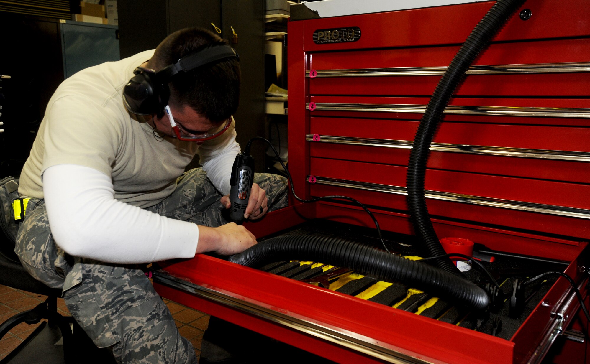U.S. Air Force Tech. Sgt. Jeremy Bennett, 14th Aircraft Maintenance Unit support section NCO in charge, uses a hand-held, high-speed tool to cut out foam used for AMU aircraft tool boxes at Misawa Air Base, Japan, Jan. 24, 2012. The foam keeps tools organized and easily seperated. (U.S. Air Force photo by Airman Kenna Jackson/Released)

