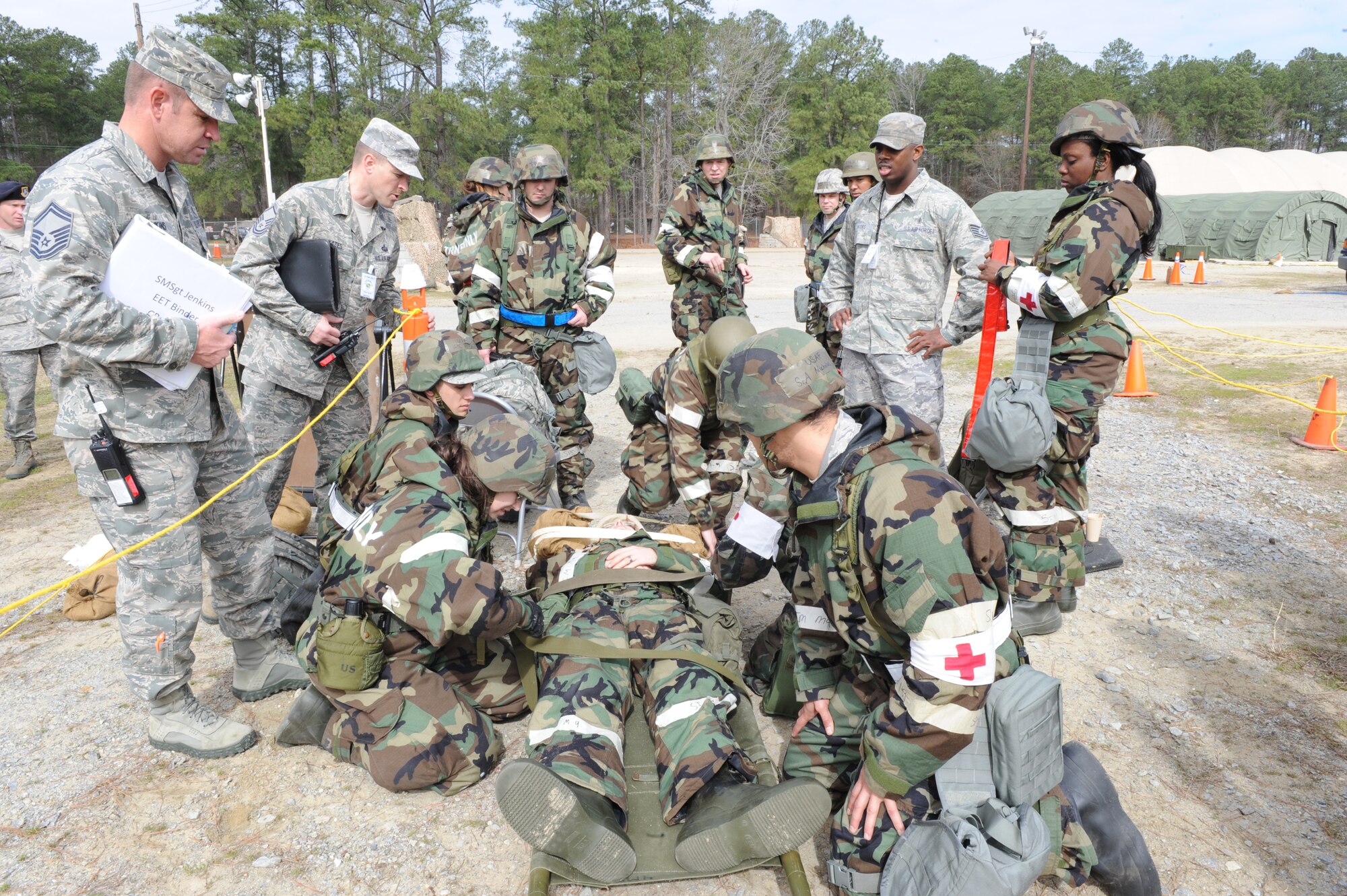 Airmen from the 4th Medical Group prepare a patient for transport while being evaluated by members of the exercise evaluation team during a phase II Operational Readiness Exercise on Seymour Johnson Air Force Base, N.C., Mar. 8, 2012. The exercise simulated aircrew flying combat operations , defending the base against attacks as well as ground forces demonstrating their ability to survive and operate under different scenarios. (U.S. Air Force photo/Staff Sgt. Courtney Richardson/Released)