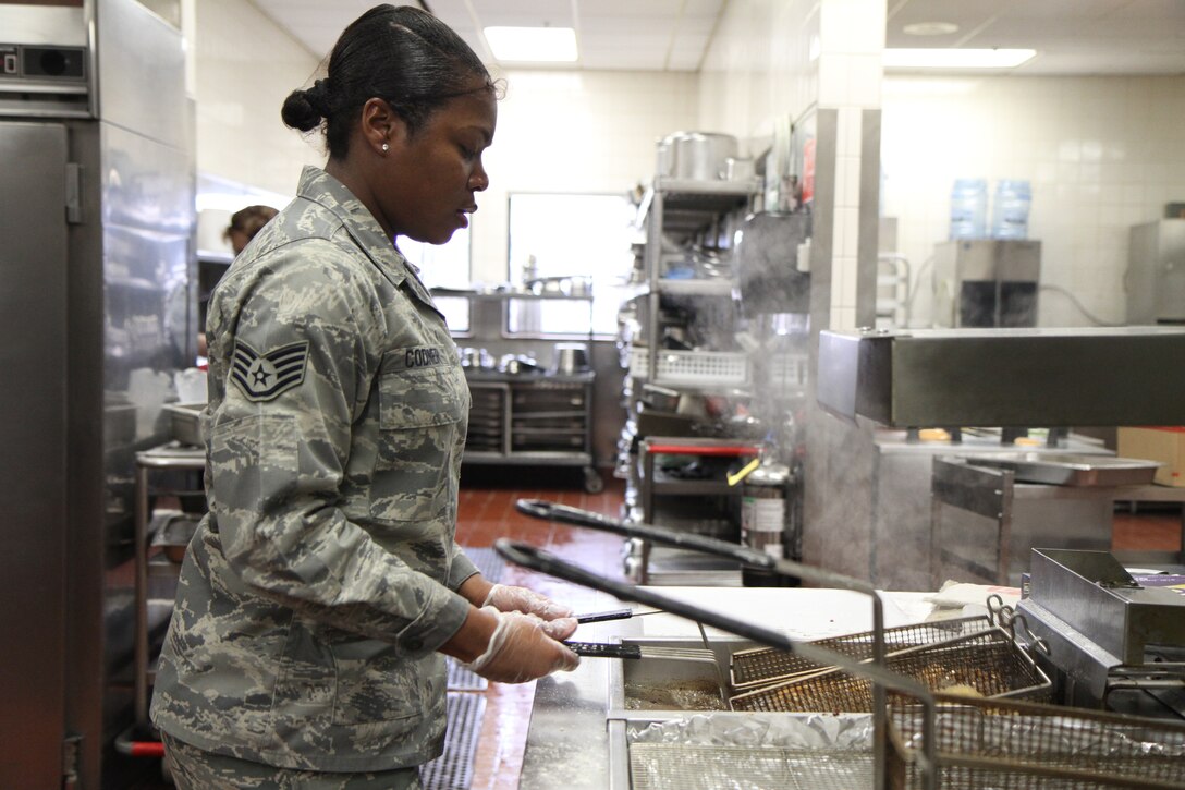 It's lunch time at Scott Air Force Base as the 932nd Airlift Wing trains Air Force Reservists in various job specialties.  Staff Sgt. Monica Kodner checks a basket of freshly-made services food to the serving tray.  Kodner and other reservists helped prepare and serve lunch at the Scott Air Force Base dining hall kitchen during a weekend drill.  She is a  member of Services Flight, 932nd Force Support Squadron. (U.S. Air Force photo/Tech. Sgt. Christopher Parr) 