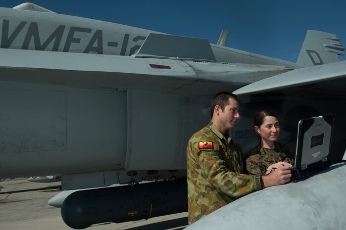 Royal Australian Air Force Leading Aircraftsman Jarred Matson,  No. 75 Squadron aircraft technician, and U.S. Marine Corps 1st Lt. Jennifer Silvers, Marine Tactical Electronic Warfare Squadron 4 troubleshoot the engine of an F-18 Hornet during Red Flag 12-3 March 8, 2012, at Nellis Air Force Base, Nev. Red Flag is a realistic combat training exercise involving the air forces of the United States and its allies. (U.S. Air Force photo by Staff Sgt. Christopher Hubenthal) 