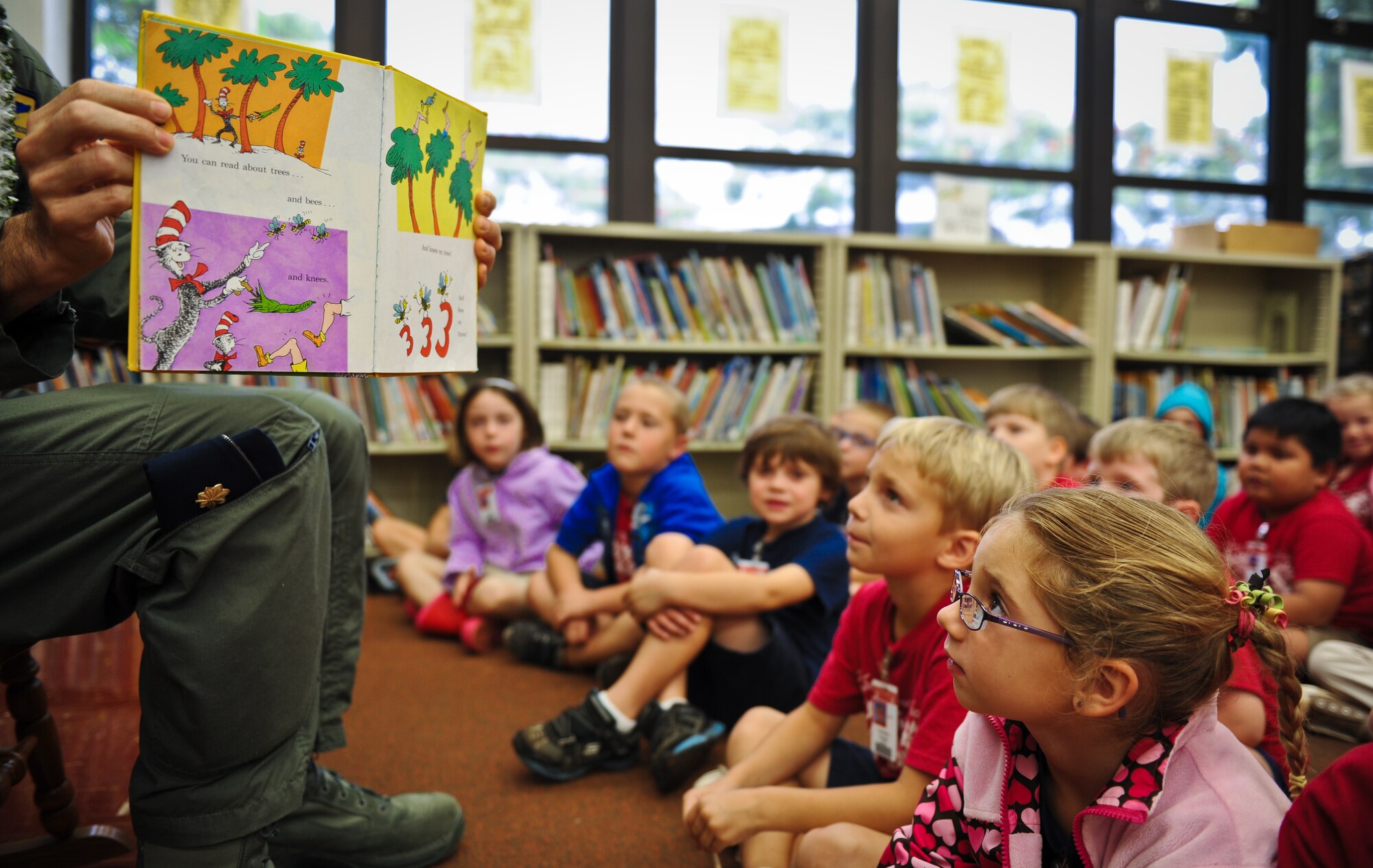 Maj. Lloyd Richardson, a 15th Wing executive officer, reads a Dr. Seuss book to a kindergarden class March 6 at Hickam Elementary on Joint Base Pearl Harbor-Hickam, Hawaii. Richardson read to the children as part of the Read Across America program honoring Dr. Seuss' birthday March 2. (U.S. Air Force photo/Senior Airman Lauren Main)