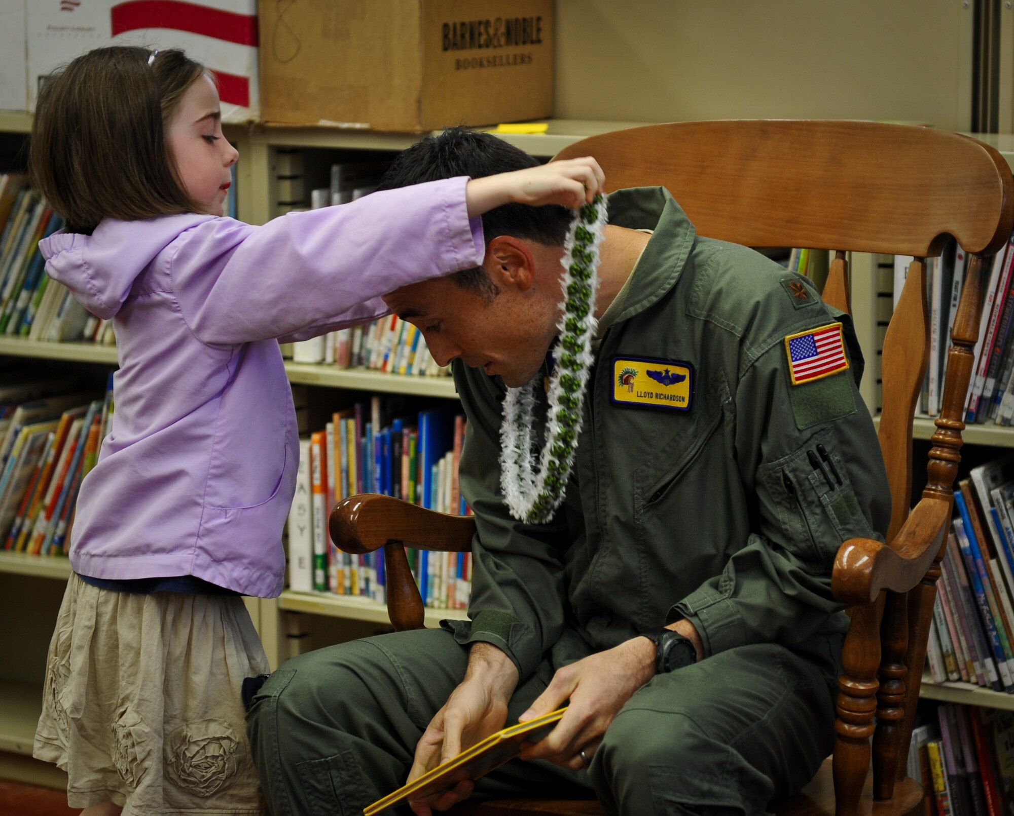 Maj. Lloyd Richardson, a 15th Wing executive officer, receives a lei from a kindergarten student March 6 at Hickam Elementary on Joint Base Pearl Harbor-Hickam, Hawaii. Richardson read to the children as part of the Read Across America program honoring Dr. Seuss' birthday March 2. (U.S. Air Force photo/Senior Airman Lauren Main)