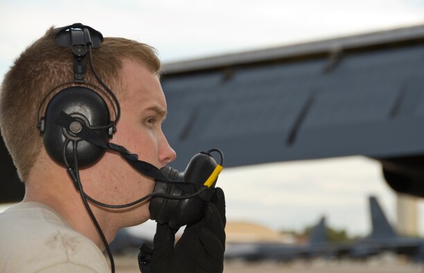 Senior Airman Bryan Turner, 20th Aircraft Maintenance Unit, communicates with members of the aircrew inside a B-52H Stratofortress on Barksdale Air Force Base, La., March 6. The aircrew communicated with Turner about what was going on inside the aircraft. If there is a problem with the aircraft, the aircrew will tell Turner and he will contact a unit that can fix the problem. (U.S. Air Force photo/Airman 1st Class Benjamin Gonsier)(RELEASED)