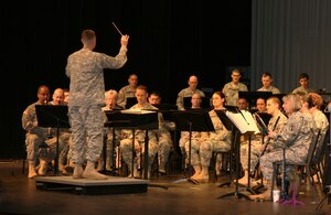 Maj. Scott McKenzie, the U.S. Army Training and Doctrine Command Band director, leads the TRADOC band during a recent performance at Warhill High School. The band also visited Lafayette High School and Bruton High School on their tour. (Courtesy photo/Released)