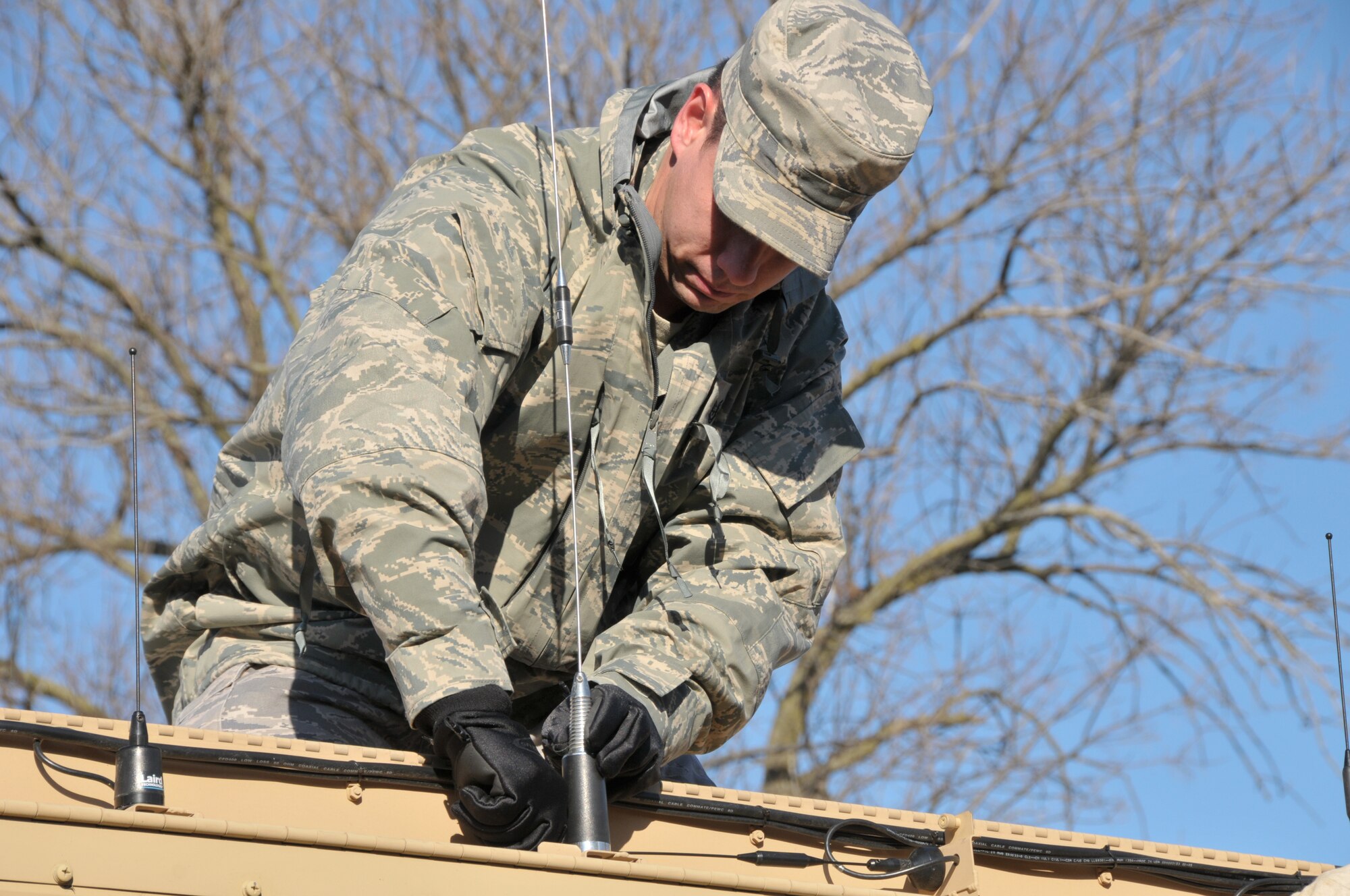 Tech. Sgt. Brent Trame, a Client System Technician with the 126th Communications Flight, attaches an exterior antenna on March 3, 2012. The antenna is part of a Contingency Response Communications System (CRCS). The CRCS is an internet based solution that allows first responders to communicate and exchange information by radio, live streaming video, wireless internet and voice over IP services. It provides highly mobile critical communications services to local, state and federal first responders with a simple to operate solution that bridges the gap between first responder agencies and various levels of command and control.The CRCS is a vehicle mounted, rapidly deployable asset that requires only two personnel and can be operational within 30 minutes of arriving on site. The 126th Air Refueling Wing, Illinois Air National Guard, can provide communications as well as other vital services in the aftermath of a natural disaster or other emergency. (National Guard photo by Master Sgt. Franklin Hayes) 