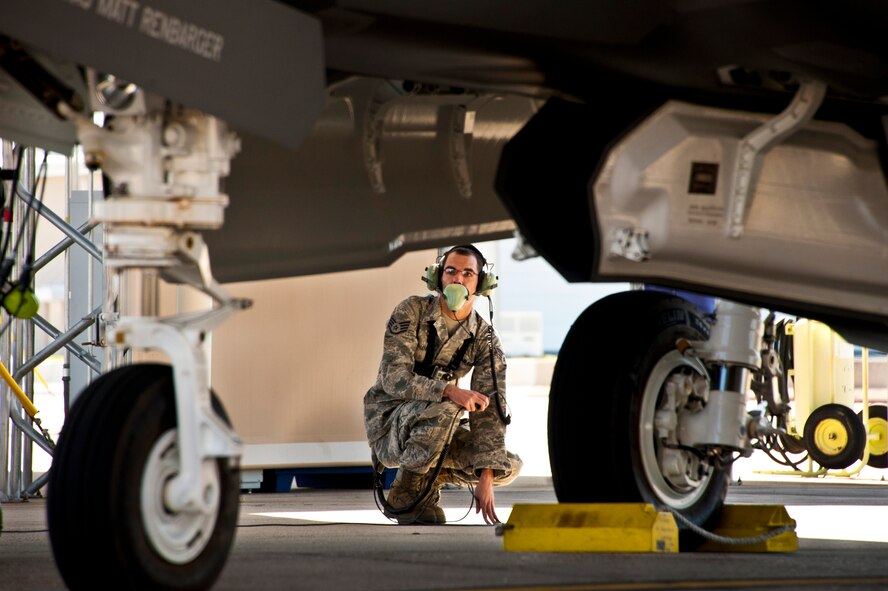 Staff Sgt. Jeremy Houser, a 33rd Aircraft Maintenance Squadron maintainer, communicates with the pilot of an F-35A Lightning II joint strike fighter during flight checks prior to the aircraft’s first-ever training sortie at Eglin Air Force Base, Fla., March 6, 2012. Houser was the crew chief for the first sortie. (U.S. Air Force photo/Samuel King Jr.)