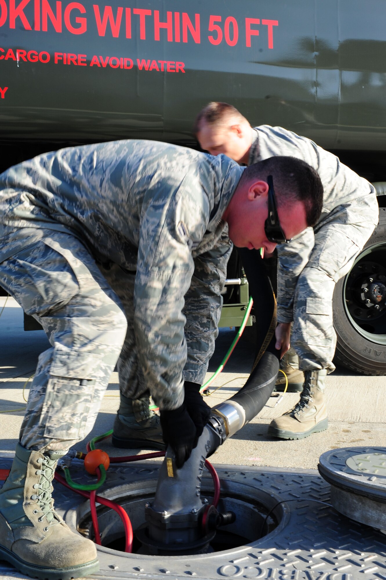 Airman 1st Class John Justiniano, a 633rd Logistics Readiness Squadron refueling unit operator, connects a hose to the hydrant fueling system on the flightline at Langley Air Force Base, Va., March 7, 2012. The 633rd LRS is responsible for all the fuels disbursed on the base, whether ground products like gas or diesel, or jet fuel designated for use in Langley AFB’s fighter jets. (U.S. Air Force photo/Airman 1st Class Kayla Newman)