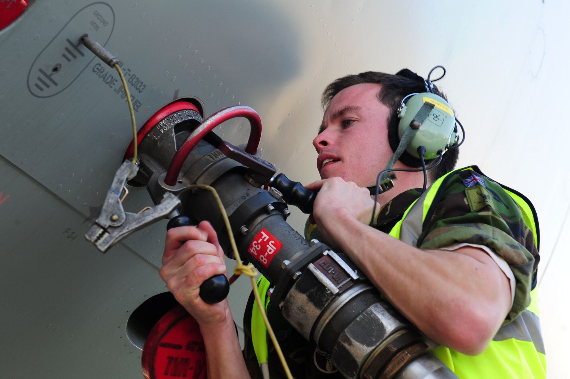 Royal Air Force Senior Craftsman Mark Butler, an avionics technician, attaches Hydrant Mobile Refueling equipment to an E-3 Sentry aircraft at Langley Air Force Base, Va., March 7, 2012. Personnel at Langley AFB are testing the new fuel delivery system, which officials say could revolutionize flightline operations and save the Air Force millions of dollars. (U.S. Air Force photo/Airman 1st Class Kayla Newman)