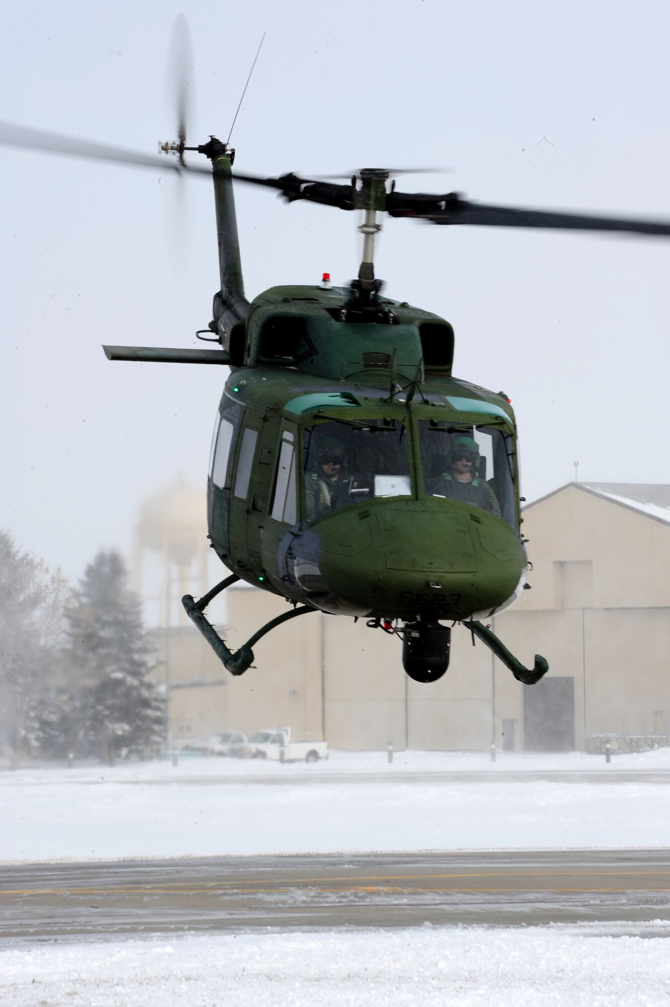 MINOT AIR FORCE BASE, N.D. -- Capt. Cory Fale, 54th Helicopter Squadron pilot and Senior Airman Jacob Gornbein, 54th HS flight engineer, take off on a routine flight operation here March 3. The 54th HS’s mission is continuous from day to day, securing the integrity of the 91st Missile Wing’s nuclear deterrence mission by providing immediate, flexible and effective combat helicopter support at any time. (U.S. Air Force photo/Senior Airman Jesse Lopez)