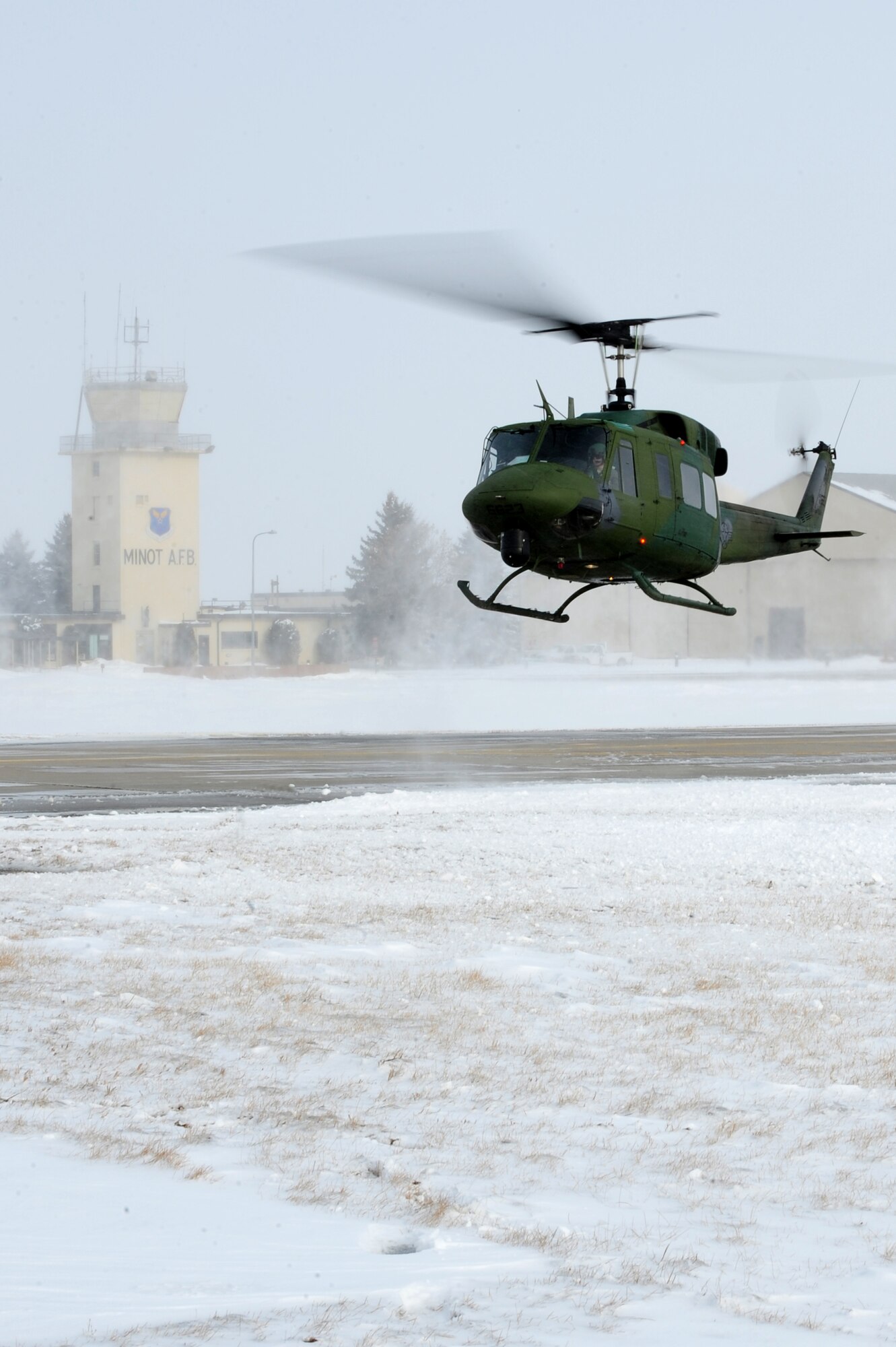 MINOT AIR FORCE BASE, N.D. -- Capt. Cory Fale, 54th Helicopter Squadron pilot and Senior Airman Jacob Gornbein, 54th HS flight engineer, take off on a routine flight operation here March 3. The 54th HS’s mission is continuous from day to day, securing the integrity of the 91st Missile Wing’s nuclear deterrence mission by providing immediate, flexible and effective combat helicopter support at any time. (U.S. Air Force photo/Senior Airman Jesse Lopez)