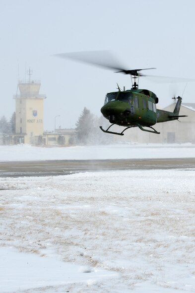 MINOT AIR FORCE BASE, N.D. -- Capt. Cory Fale, 54th Helicopter Squadron pilot and Senior Airman Jacob Gornbein, 54th HS flight engineer, take off on a routine flight operation here March 3. The 54th HS’s mission is continuous from day to day, securing the integrity of the 91st Missile Wing’s nuclear deterrence mission by providing immediate, flexible and effective combat helicopter support at any time. (U.S. Air Force photo/Senior Airman Jesse Lopez)