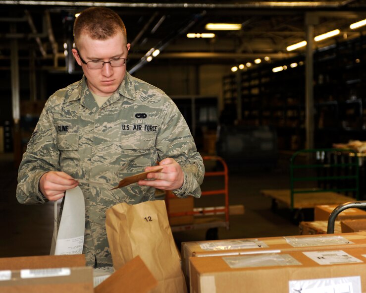 MINOT AIR FORCE BASE, N.D. -- Airman 1st Class Codey Cline, 5th Logistics Readiness Squadron traffic management apprentice, labels cargo here March 2. The traffic management team receives approximately 250 boxes of varying cargo from outbound or inbound Airmen each day, which is then either shipped to the customer or placed in storage until pick up. A Department of Defense-wide system is now utilized for the purpose of household goods shipping during Permanent Change of Stations. The Defense Personal Property System form can be accessed online at www.move.mil-- remember to disable a computer’s pop-up blocker for access. (U.S. Air Force photo/Airman 1st Class Stephanie Ashley)

