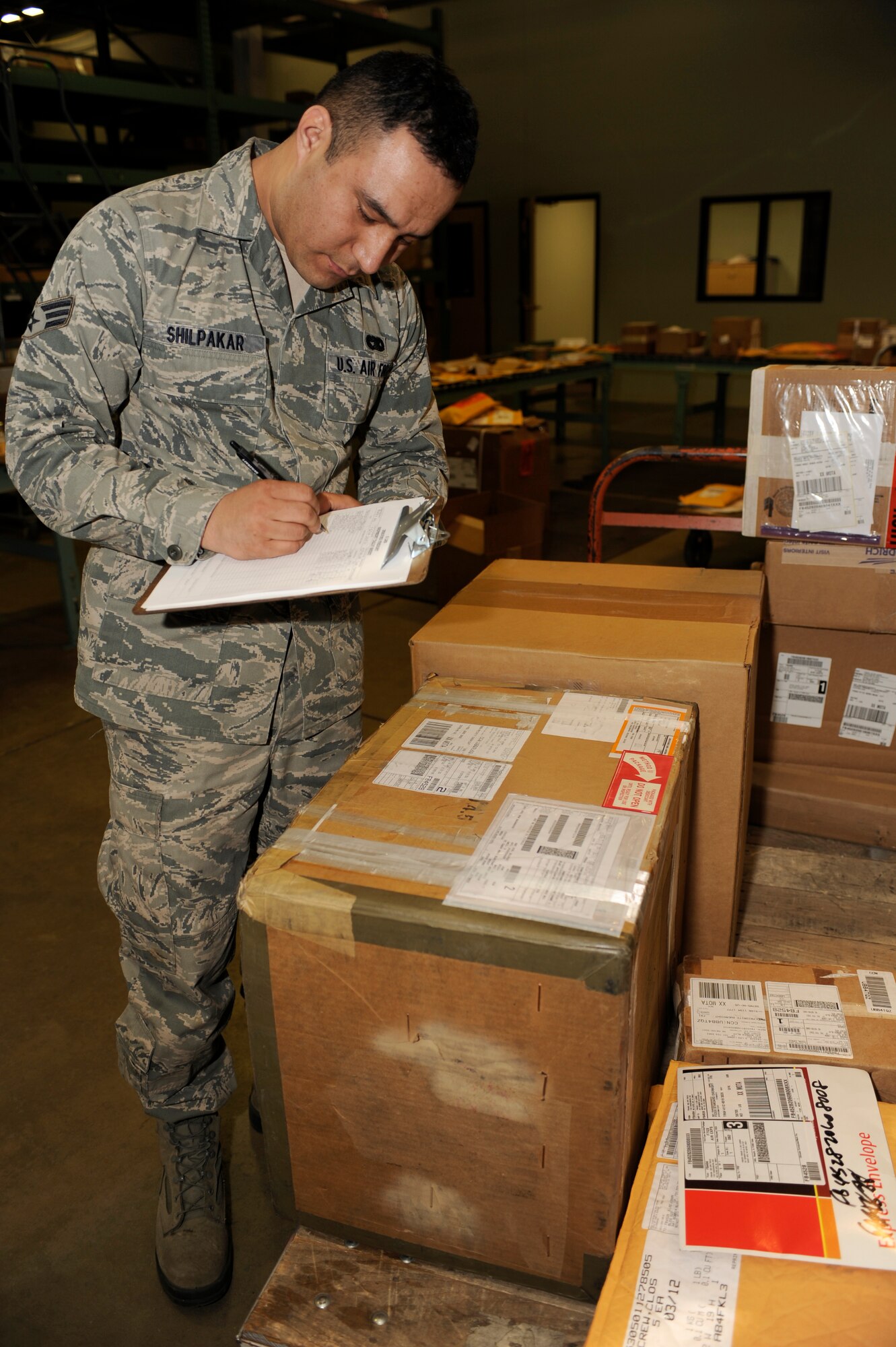 MINOT AIR FORCE BASE, N.D. – Senior Airman Rajeev Shilpakar, 5th Logistics Readiness Squadron traffic management journeyman, checks in cargo here March 2. The traffic management team receives approximately 250 boxes of varying cargo from outbound or inbound Airmen each day, which is then either shipped to the customer or placed in storage until pick up. A Department of Defense-wide system is now utilized for the purpose of household goods shipping during Permanent Change of Stations. The Defense Personal Property System form can be accessed online at www.move.mil-- remember to disable a computer’s pop-up blocker for access. (U.S. Air Force photo/Airman 1st Class Stephanie Ashley)