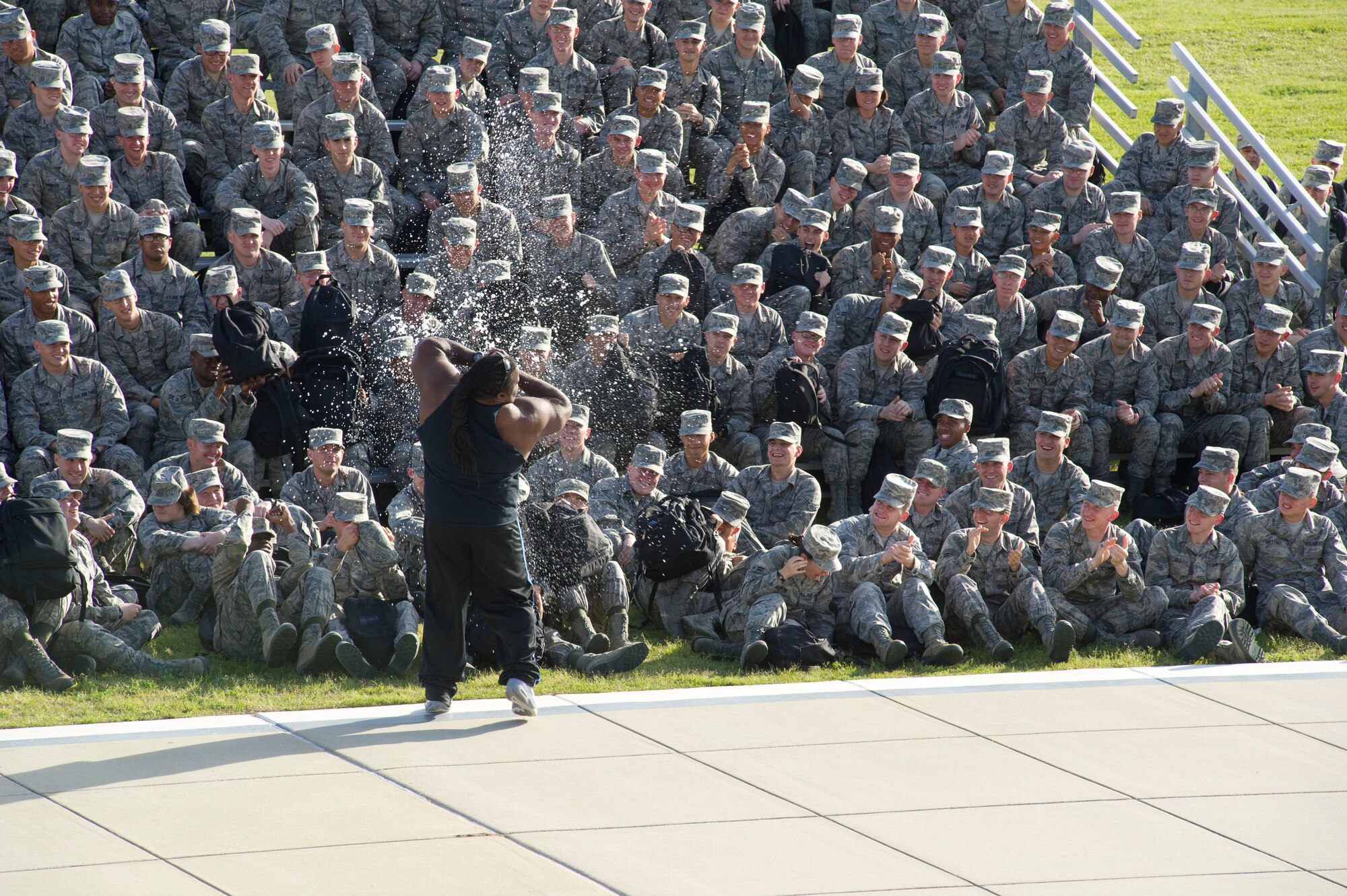 Randall Harris, Team Impact leader, breaks open a soda can with his bare hands in front of technical training students during the team’s performance at the Levitow Support Training Center March 6, 2012,Keesler Air Force Base, Miss. Team Impact performs feats that require incredible strength to raise spiritual and physical awareness.  (U.S. Air Force photo by Adam Bond)