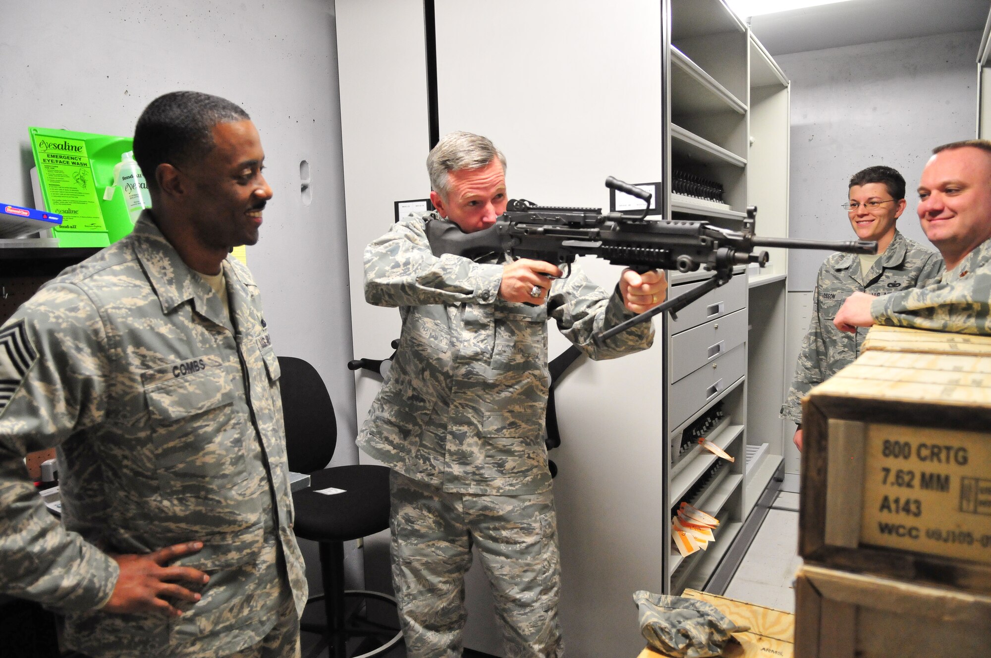 Brig. Gen. William B. Binger (center) commander, 10th Air Force, gets a solid feel of the M249 Machine Gun while Maj. Donovan Cody (right) the 710th Security Forces Squadron commander gives the general information about the weapon at the 710th SFS on March 2, 2012 at Buckley Air Force Base, Colo. The general visited the 310th Space Wing to learn about their space mission and to visit with the members of the 310th SW. (U.S. Air Force photo/Tech. Sgt. Nicholas B. Ontiveros)