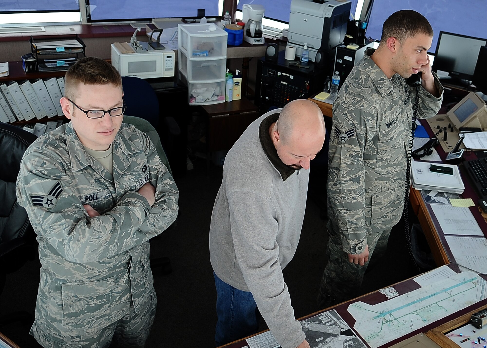 MINOT AIR FORCE BASE, N.D. – Members of the 5th Operations Support Squadron: Senior Airman Mason Poll, air traffic controller, Michael Porreca, ATC watch Supervisor, and Senior Airman Weston Whitsett, air traffic controller, ensure clarity and safety of the flight line here March 2. Among the duties of  air traffic controllers is to operate air traffic systems to expedite and maintain a safe and orderly flow of air traffic. (U.S. Air Force photo/Airman 1st Class Kristoffer Kaubisch)
