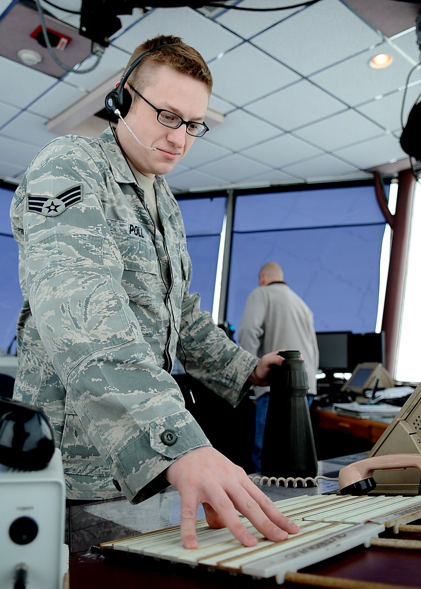 MINOT AIR FORCE BASE, N.D. – Senior Airman Mason Poll, 5th Operations Support Squadron air traffic controller, annotates coordinates of flight line discrepancies at the ATC tower March 2. Among the duties of  air traffic controllers is to operate air traffic systems to expedite and maintain a safe and orderly flow of air traffic. (U.S. Air Force photo/Airman 1st Class Kristoffer Kaubisch)