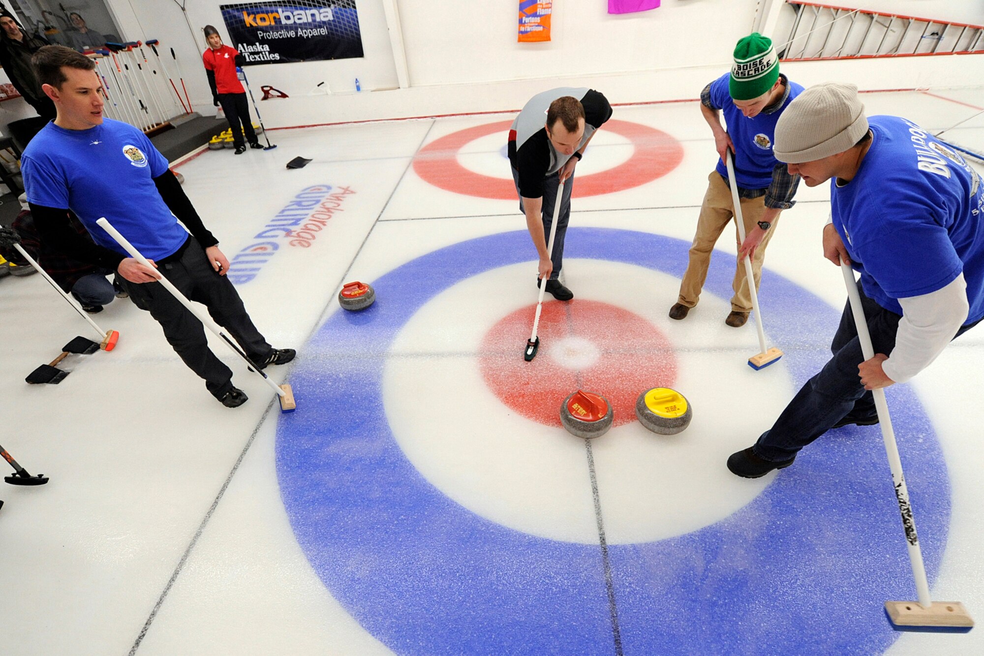 Curlers from the 962nd AACS and the 525th Fighter Squadron (blue shirts) vie for position of their teams? stones during the championship game of the 3rd Wing curling competition March 2 at the Anchorage Curling Club. The 525th progressed through the competition unbeaten, but lost the final two games to the Royal Canadian Air Force contingent of the 962nd AACS to finish as runners up.(U.S. Air Force photo/John Pennell)