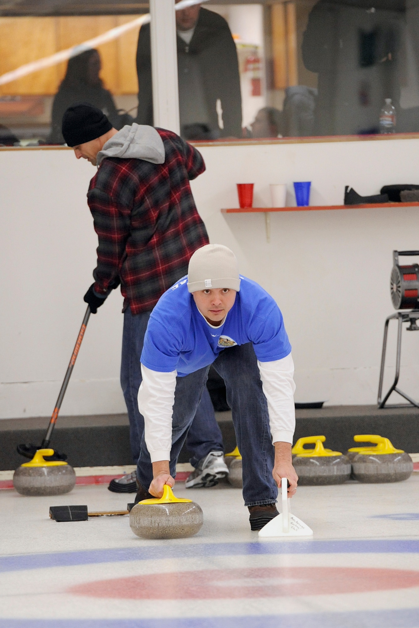 Capt. Vaimana Conner, 525th Fighter Squadron, prepares for a shot in thechampionship game of 3rd Wing's curling competition March 2 at the Anchorage Curling Club.  The 525th went into the championship game undefeated, but lost two games to the 962nd AACS to finish as runners up. (U.S. Air Force photo/John Pennell)