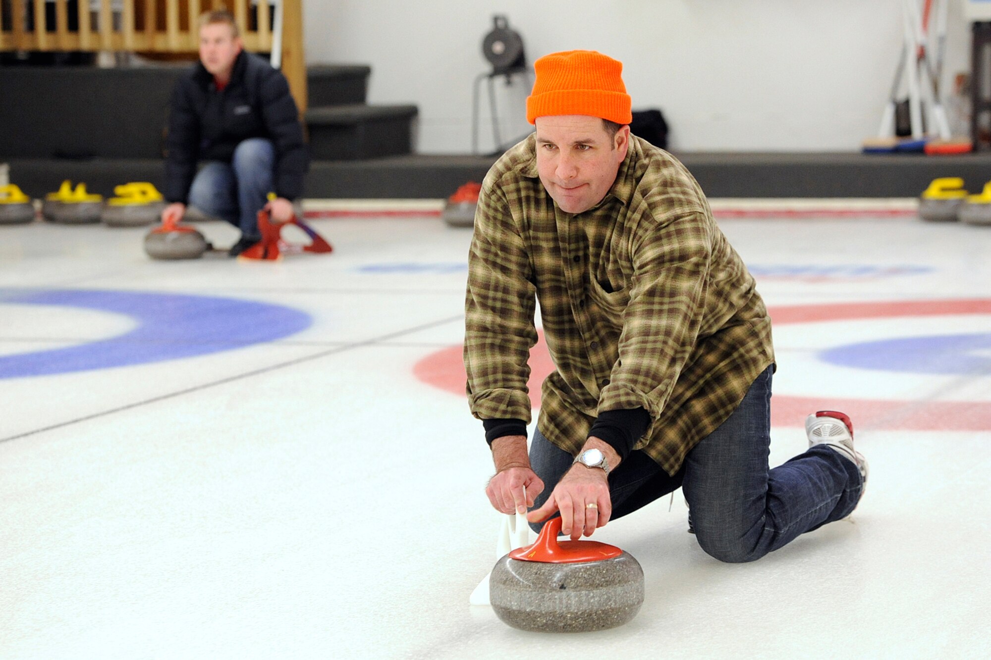 Lt. Col. James Suhr, 3rd Operations Support Squadron commander, releases a shot in the 3rd Wing curling competition March 2 at the Anchorage Curling Club. All eight 3rd Wing squadrons provided five-person teams to take part in the friendly competition. The winning team came from the Royal Canadian Air Force contingent of the 962nd Airborne Air Control Squadron. (U.S. Air Force photo/John Pennell)