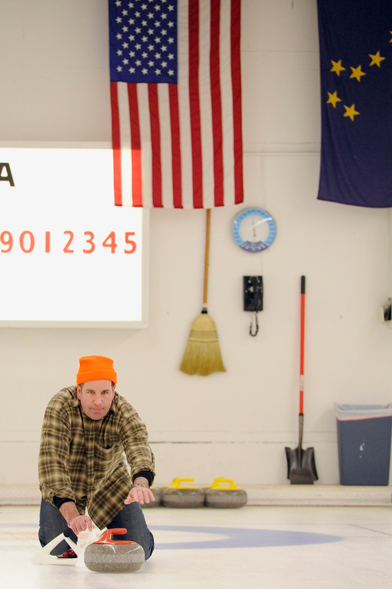 Lt. Col. James Suhr, 3rd Operations Support Squadron commander, releases a shot in the 3rd Wing curling competition March 2 at the Anchorage Curling Club. All eight 3rd Wing squadrons provided five-person teams to take part in the friendly competition. The winning team came from the Royal Canadian Air Force contingent of the 962nd Airborne Air Control Squadron. (U.S. Air Force photo/John Pennell)