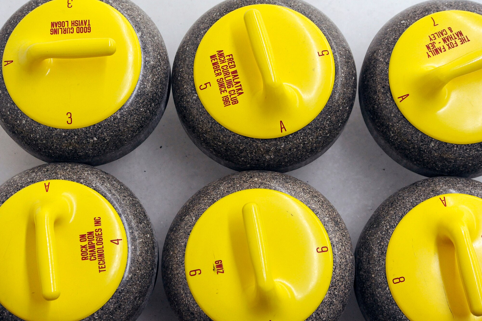 Curling stones wait for the action to begin during the 3rd Wing curling competition March 2 at the Anchorage Curling Club. (U.S. Air Force photo/John Pennell)