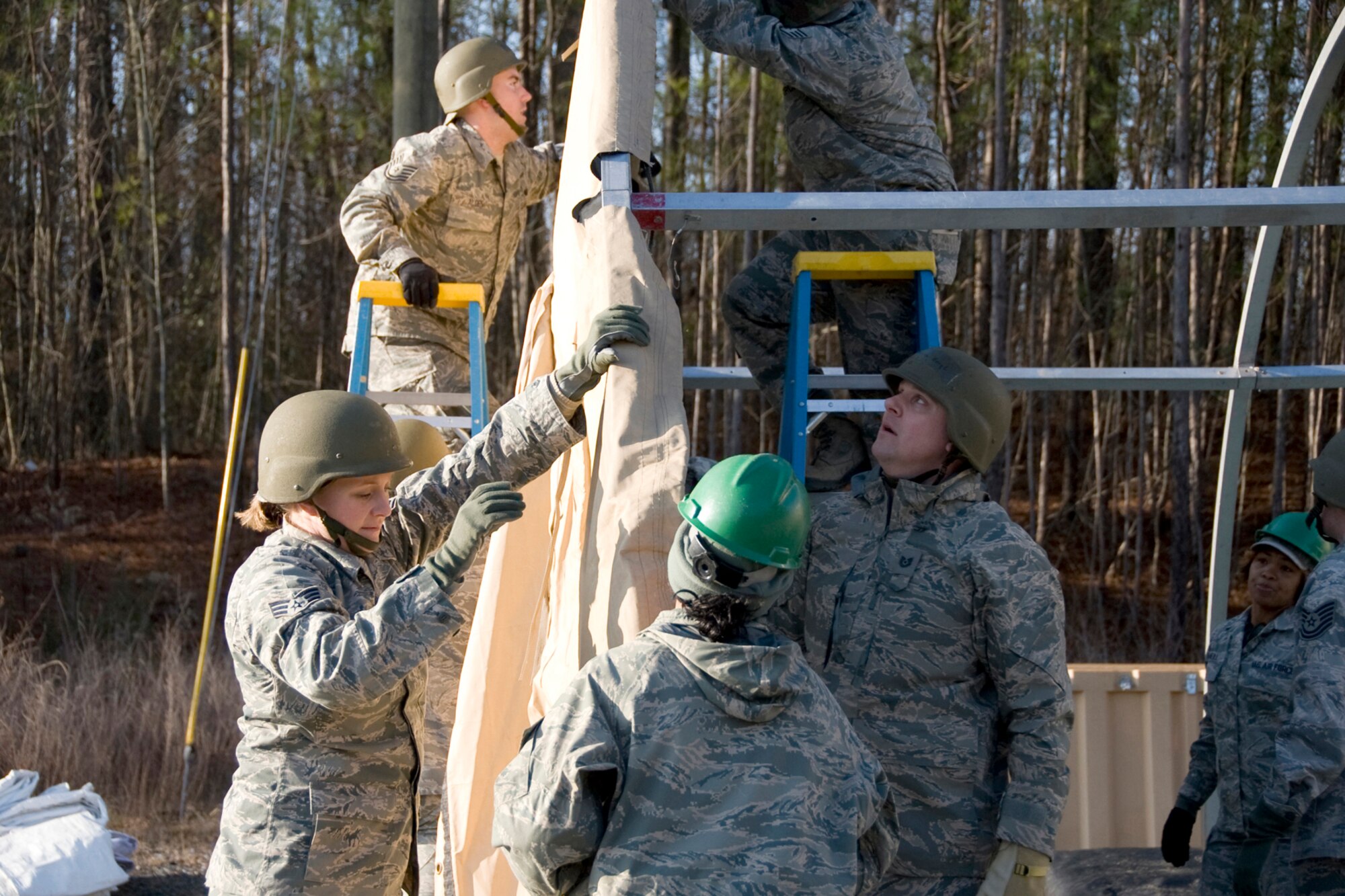 Tech. Sgt. Aaron Alden, Tech. Sgt. Thomas Bergl and Senior Airman Holly Kneisl work with other Air Force members to construct the front wall of a SSS structure during the Silver Flag exercise.  Airmen from the 148th Fighter Wing Force Support Squadron participated in a weeklong contingency operations training exercise from February 18-25 at Dobbins Air Reserve Base.  (U.S. Air Force photo by Staff Sgt. Paul Santikko)

http://www.minnesotanationalguard.org/press_room/e-zine/articles/index.php?item=3688