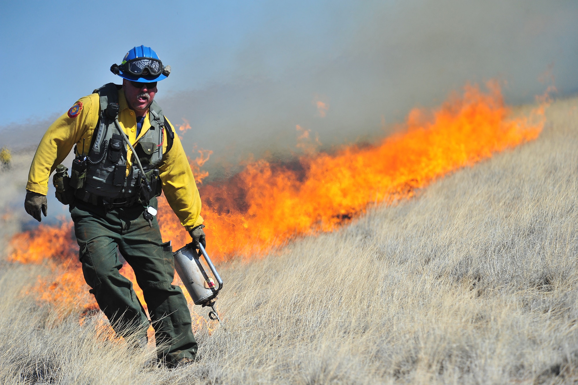 Kerry Gregg, Melrose Air Force Range fire management officer, uses a drip torch to start fires for a controlled burn, March 5, 2012. Controlled burns are used to deprive wild fires of fuel and to prevent them from spreading. Melrose Range provides a space for realistic training of ground and air forces and is operated by Cannon Air Force Base, N.M. (U.S. Air Force photo  by Tech. Sgt. Josef Cole)
