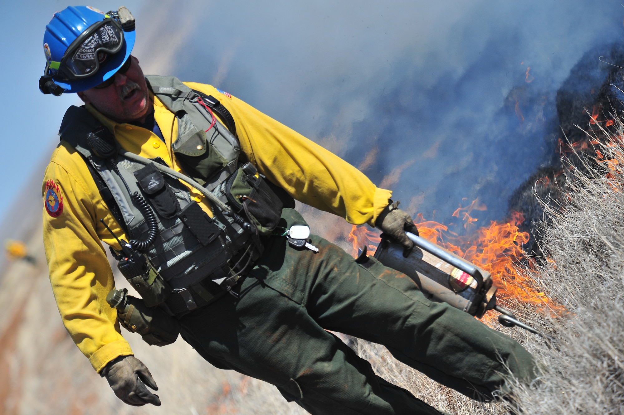Kerry Gregg, Melrose Air Force Range fire management officer, uses a drip torch to start fires for a controlled burn, March 5, 2012. Controlled burns are used to deprive wild fires of fuel and to prevent them from spreading. Melrose Range provides a space for realistic training of ground and air forces and is operated by Cannon Air Force Base, N.M. (U.S. Air Force photo  by Tech. Sgt. Josef Cole)