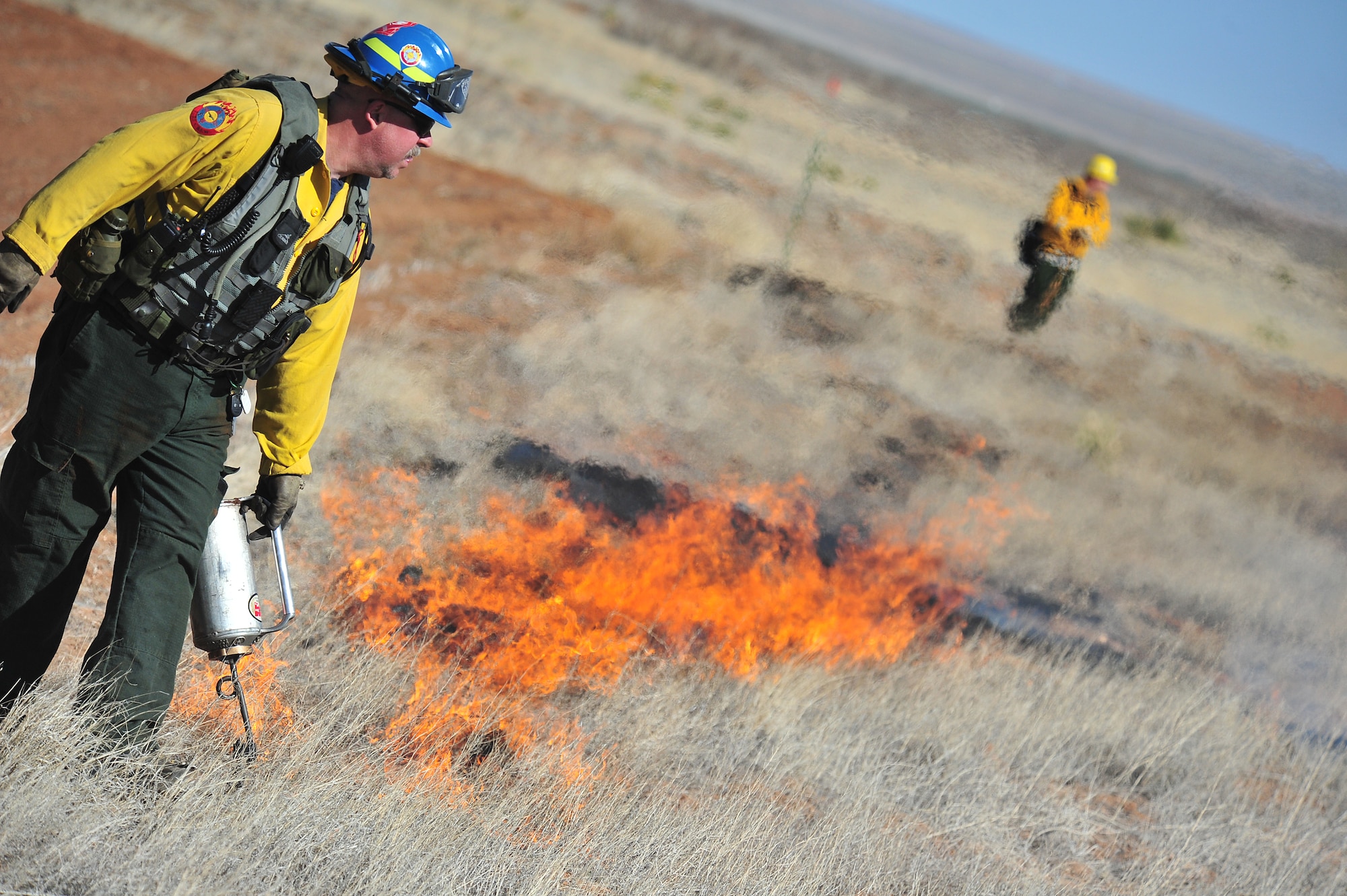 Kerry Gregg, Melrose Air Force Range fire management officer, uses a drip torch to start fires for a controlled burn, March 5, 2012. Controlled burns are used to deprive wild fires of fuel and to prevent them from spreading. Melrose Range provides a space for realistic training of ground and air forces and is operated by Cannon Air Force Base, N.M. (U.S. Air Force photo  by Tech. Sgt. Josef Cole)